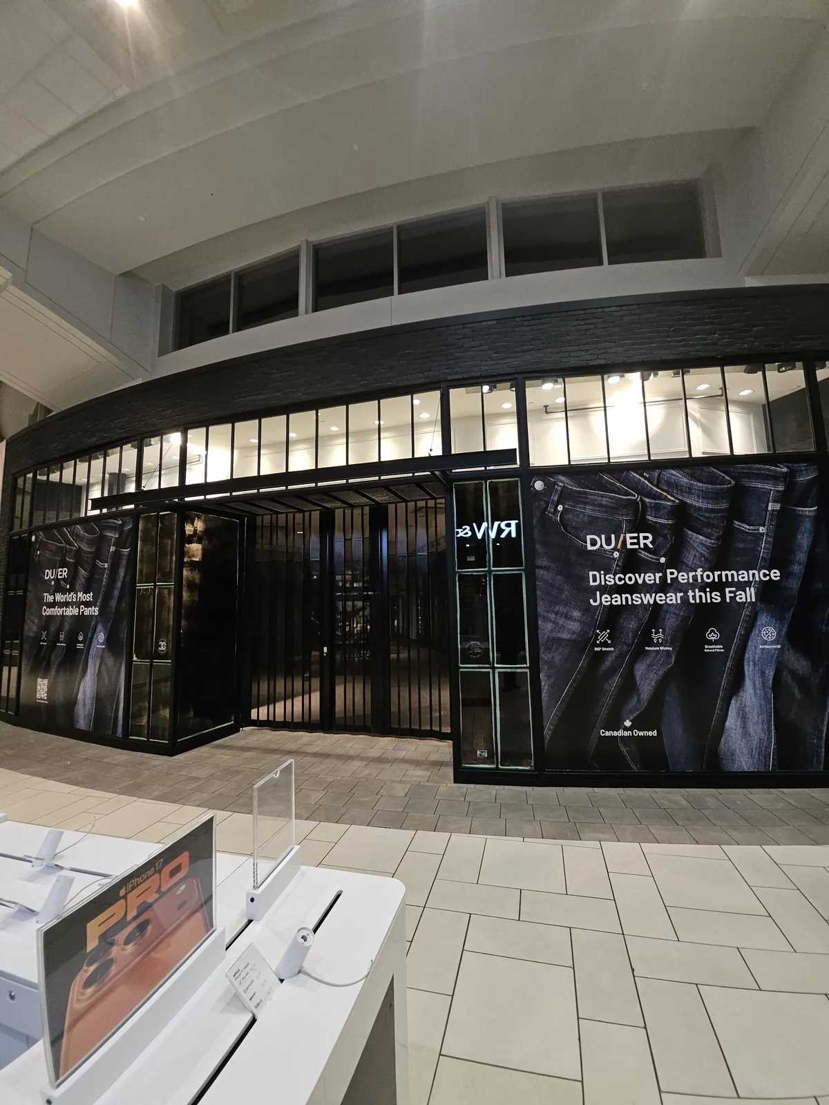 Curved storefront hoarding installation Calgary mall